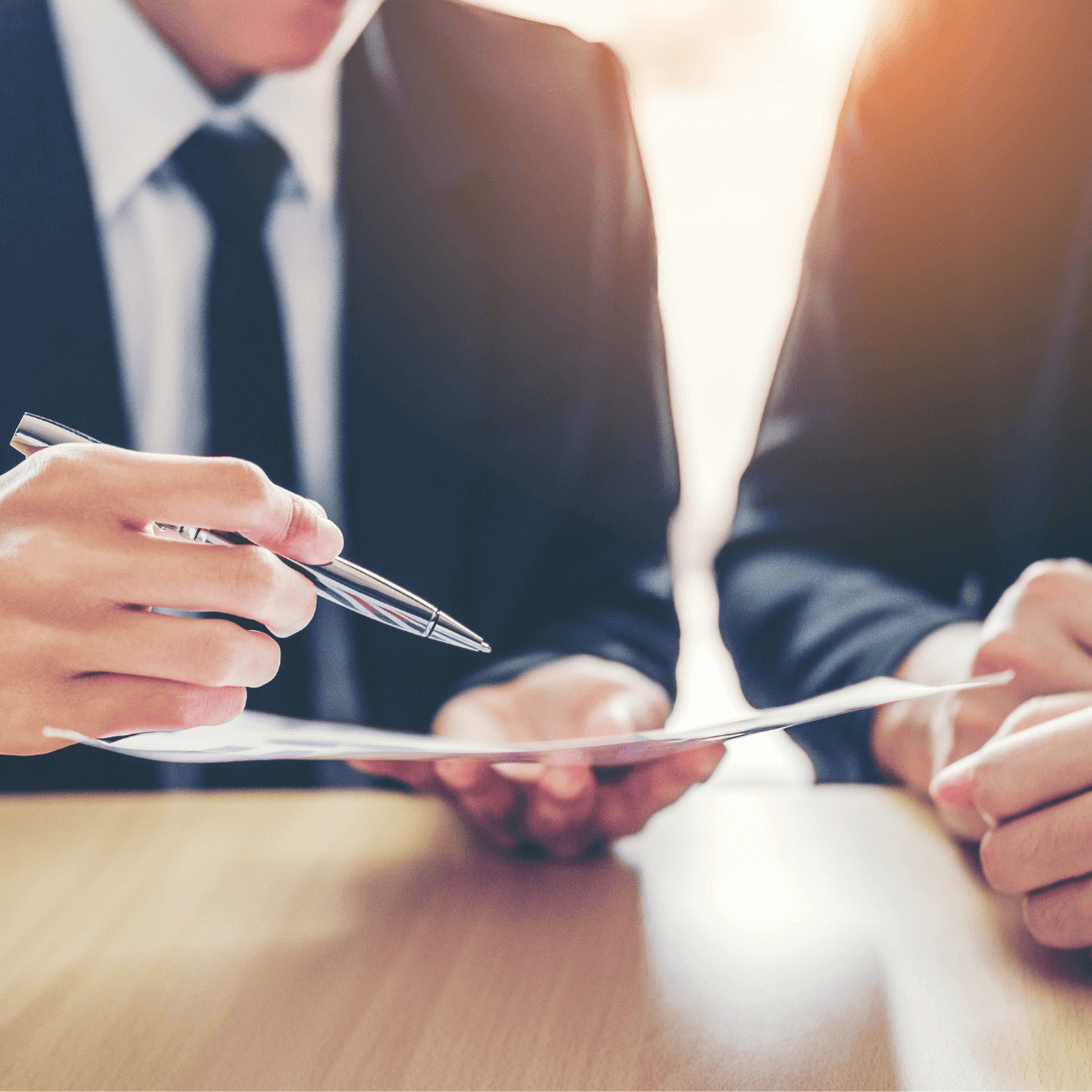 Picture of people discussing a document.